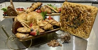 a tray of pastries and fruit on a counter